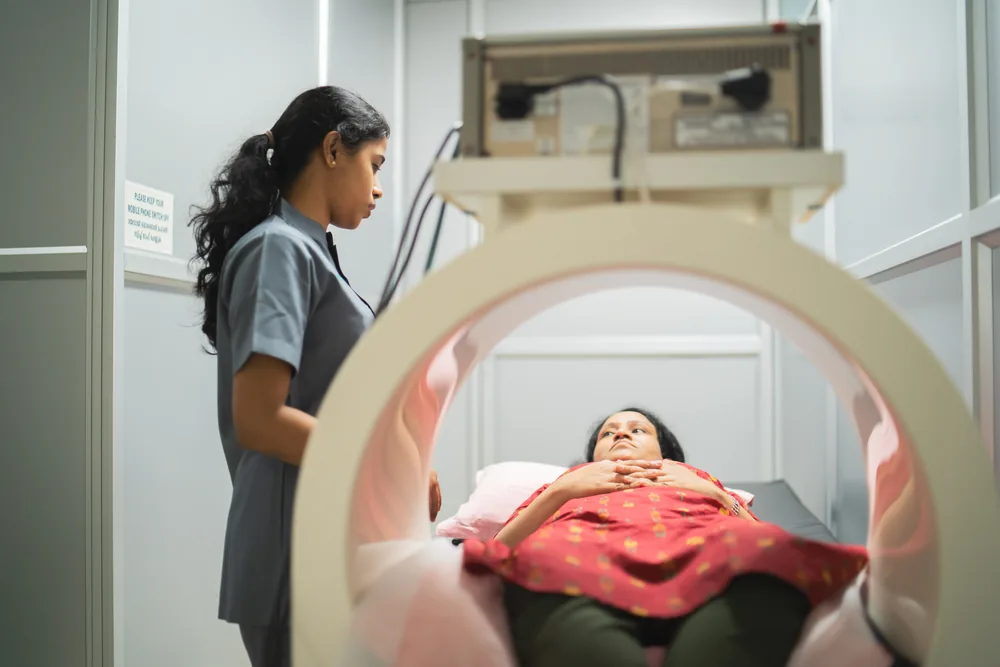 A patient lying inside a pulsed signal therapy device