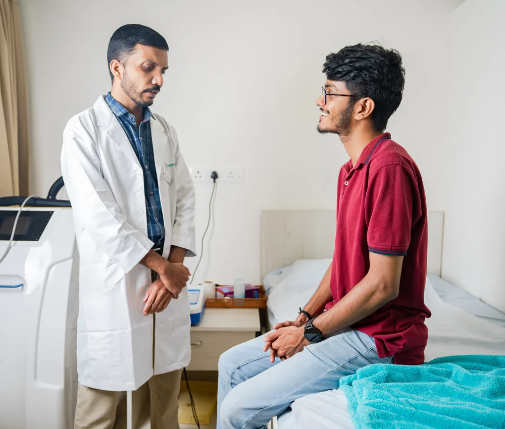 A physiotherapist assessing a patient during a spine consultation