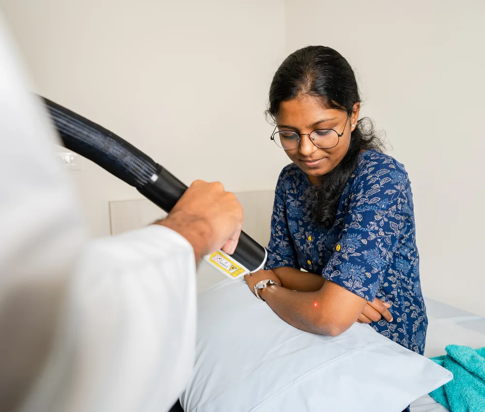 A physiotherapist assessing a patient during a spine consultation