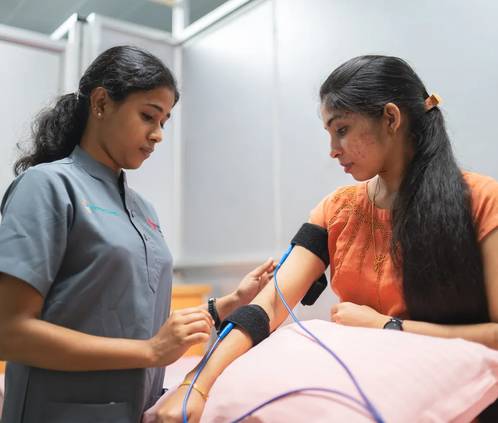 A physiotherapist giving electrotherapy to a patient
