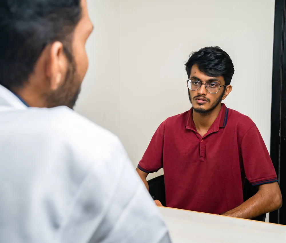 A physiotherapist assessing a patient during a spine consultation