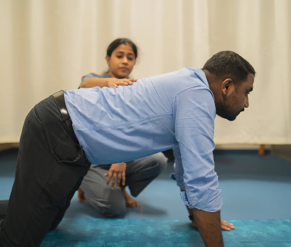 A physiotherapist guiding a patient through a rehabilitation exercise
