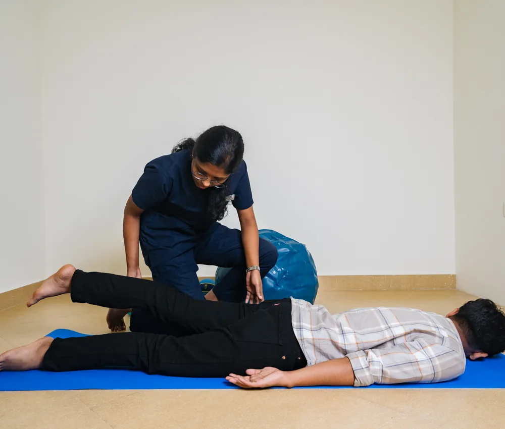 A physiotherapist guiding a patient through a rehabilitation exercise