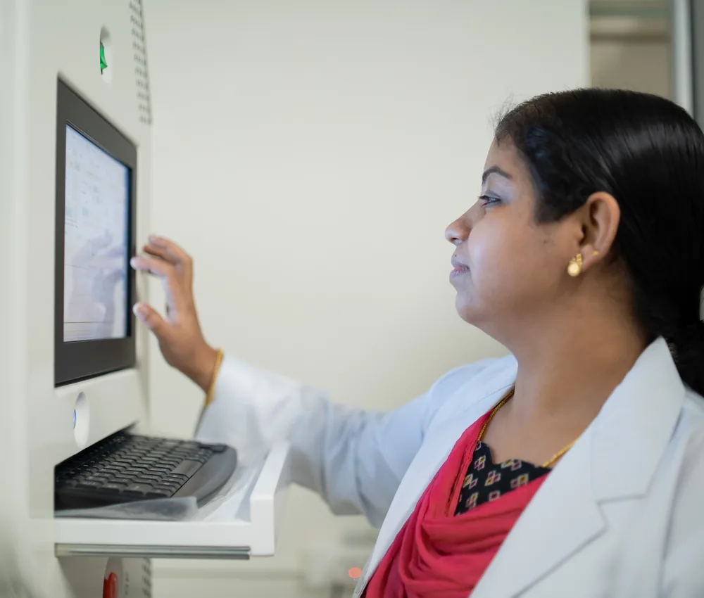 A physiotherapist operating the screen of a spinal decompression system