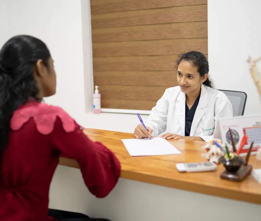 A physiotherapist assessing a patient during a spine consultation